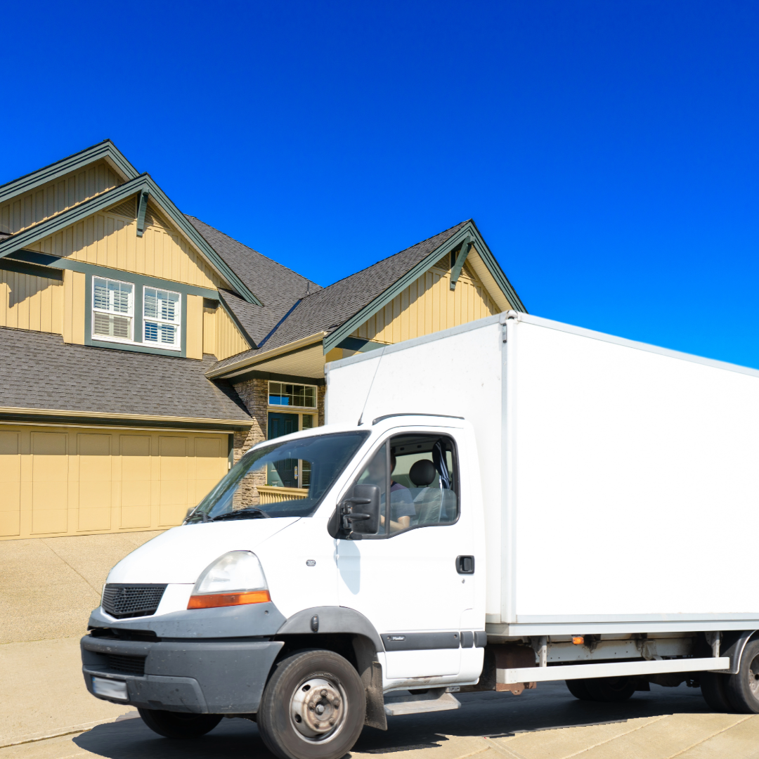White moving truck in front of house