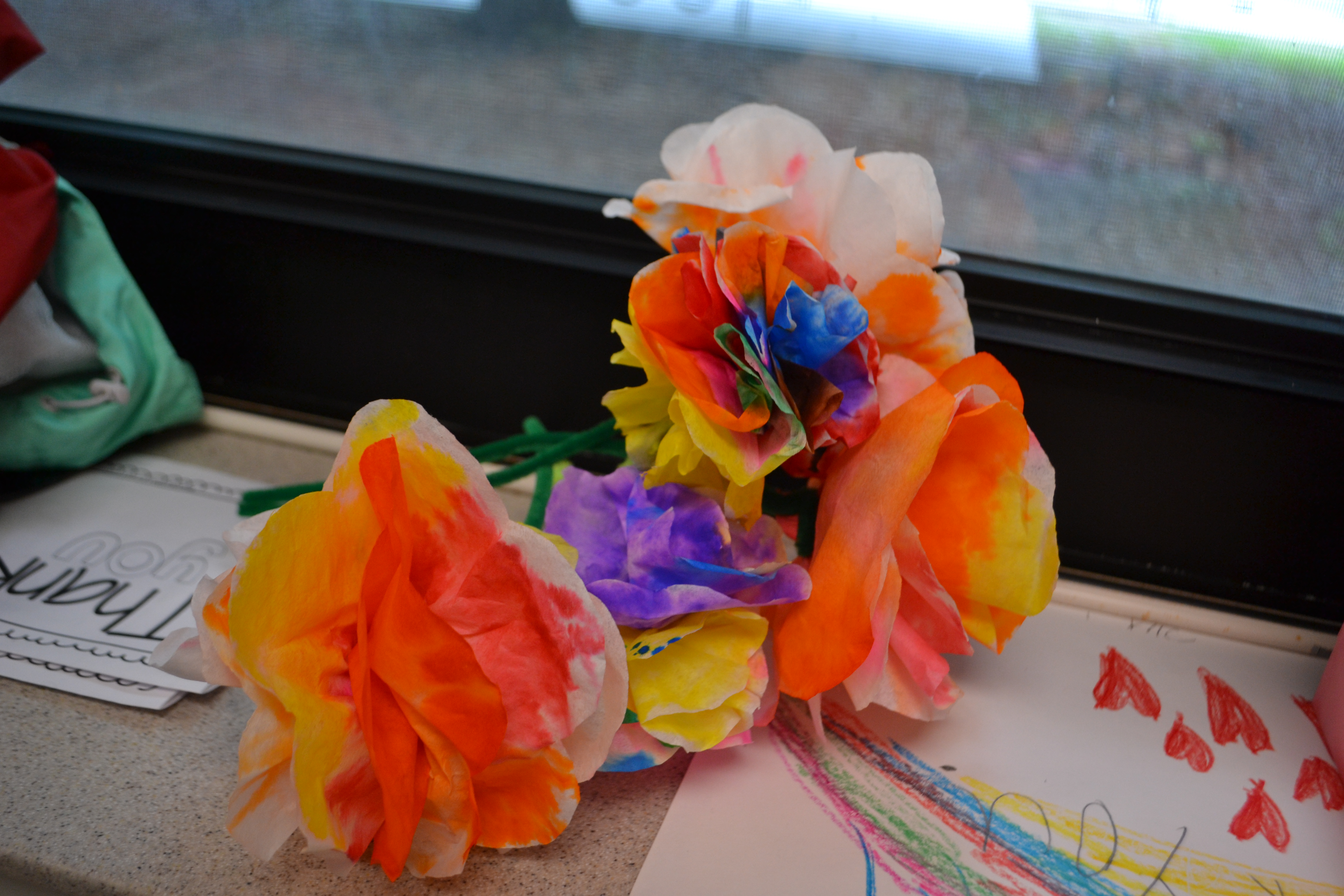 colorful flowers made of tissue paper and pipe cleaners