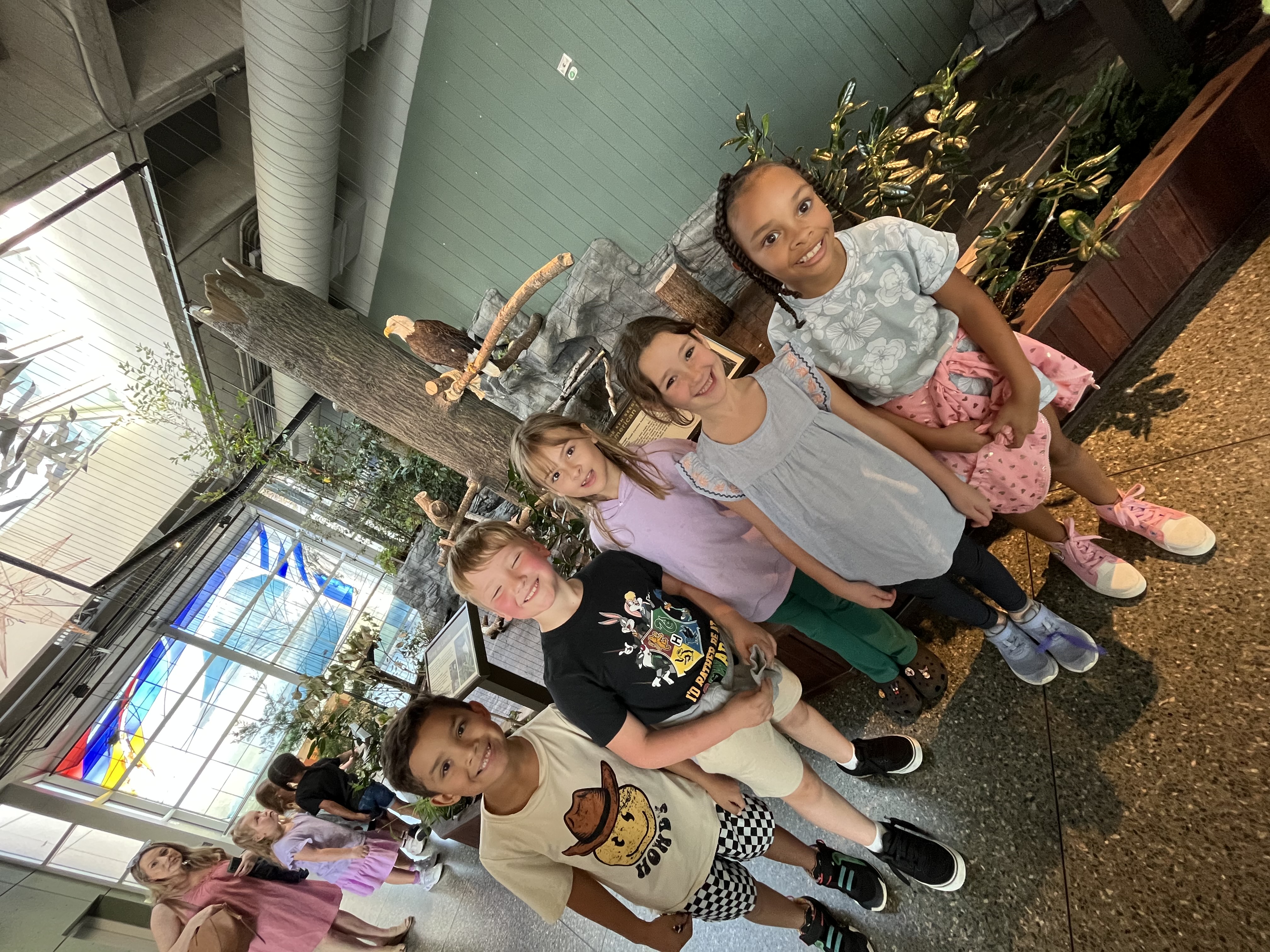 2nd grade students pose in front of a bald Eagle