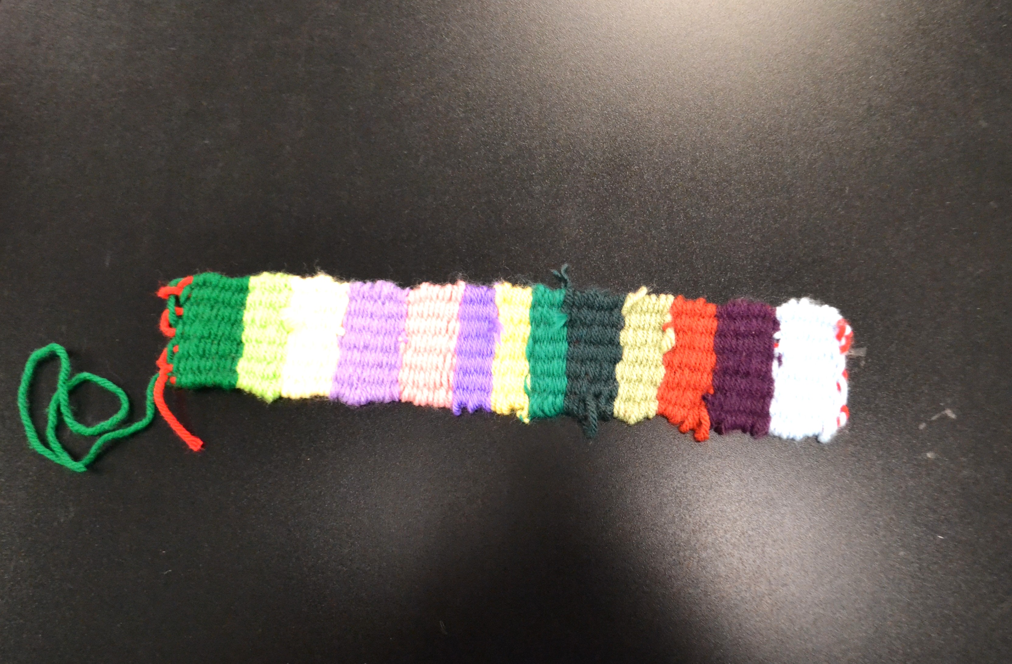 Finished, multicolored weaving project using acrylic yarn